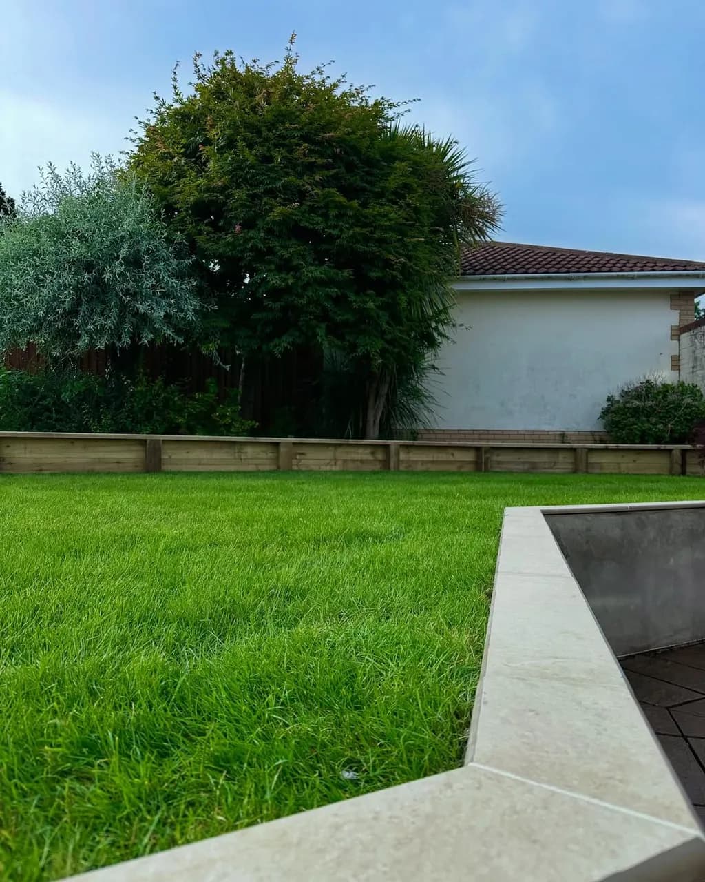 Full garden renovation - levelling, sleeper beds, fresh turf, porcelain copings and new steps