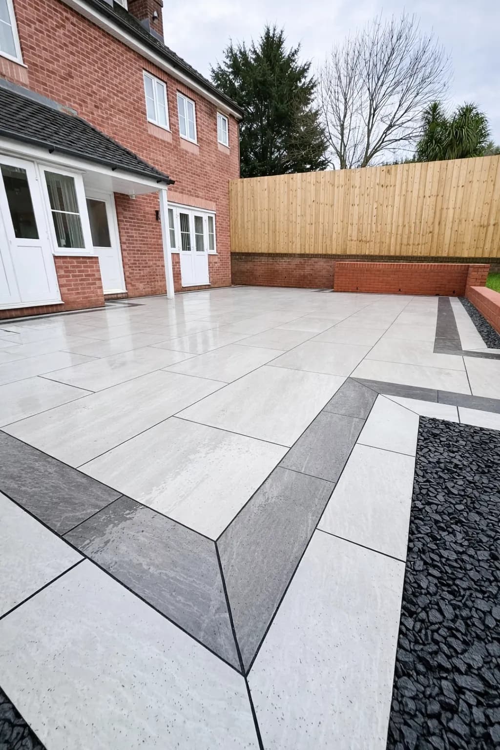 Low-maintenance porcelain patio creating usable outdoor space at a property in Pontypool