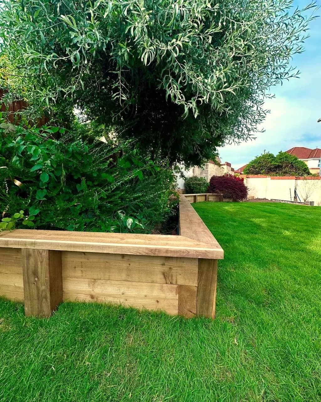 Rendered retaining walls and new garden steps installed in Cwmbran, with the area levelled and finished with fresh turf.