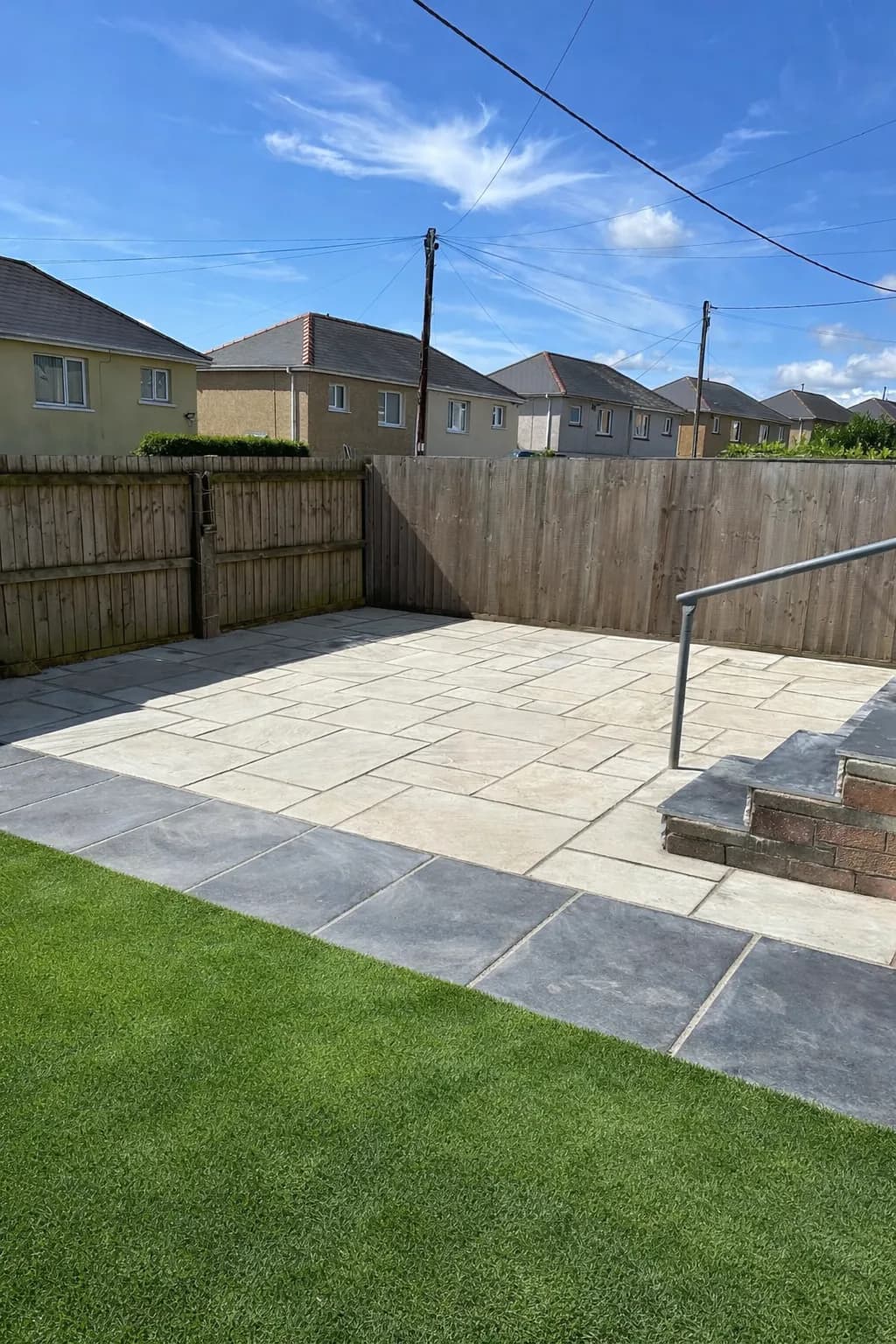 Front garden transformation featuring Indian sandstone patio, new timber fencing and modern summerhouse installation.