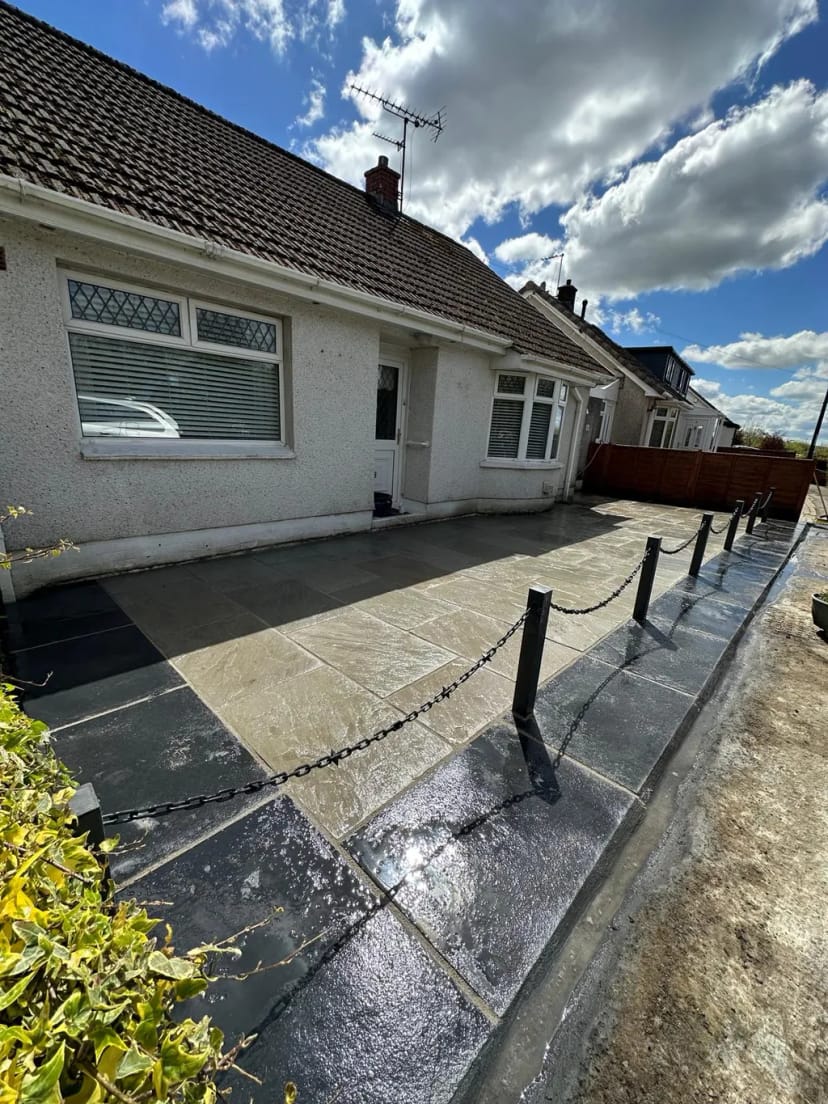 Sandstone patio with black limestone borders
