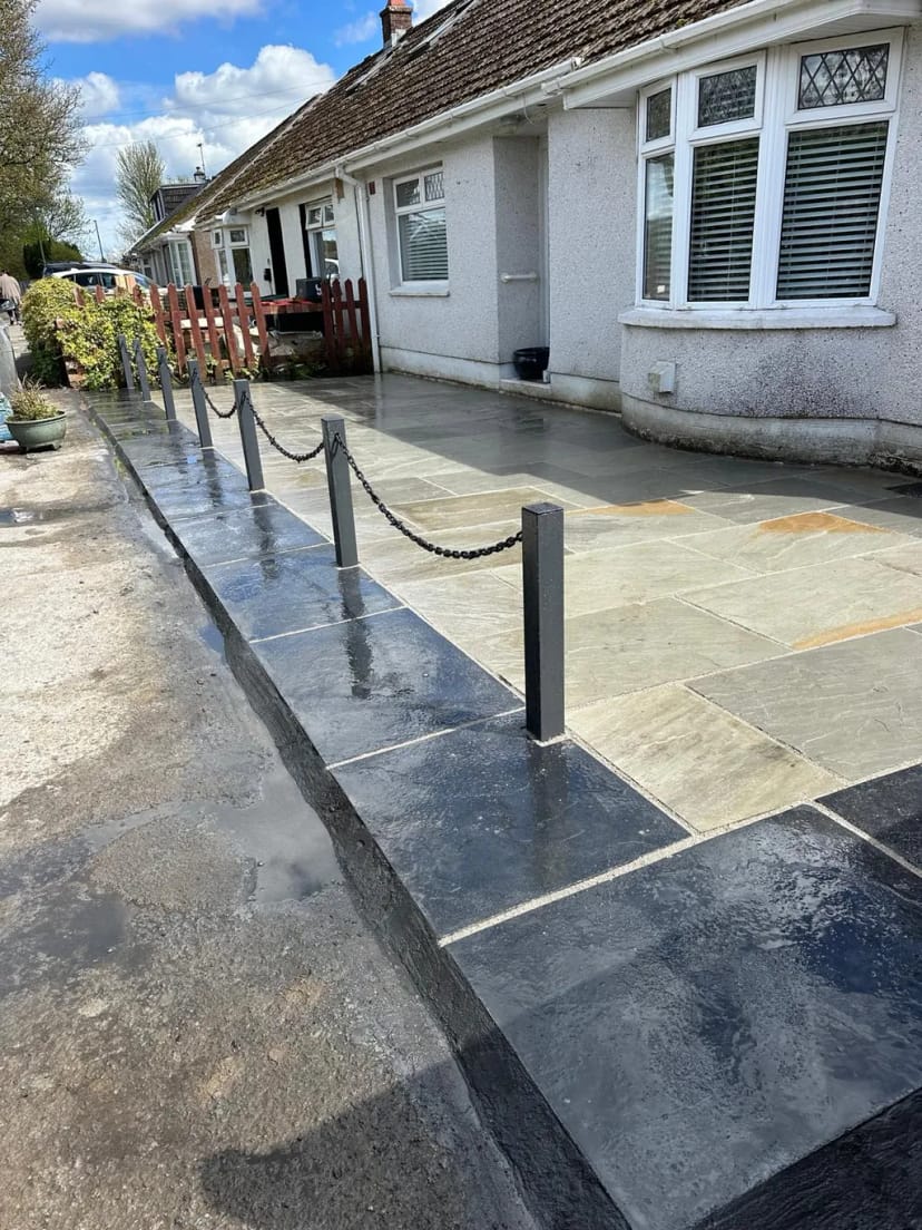 Sandstone patio with black limestone borders