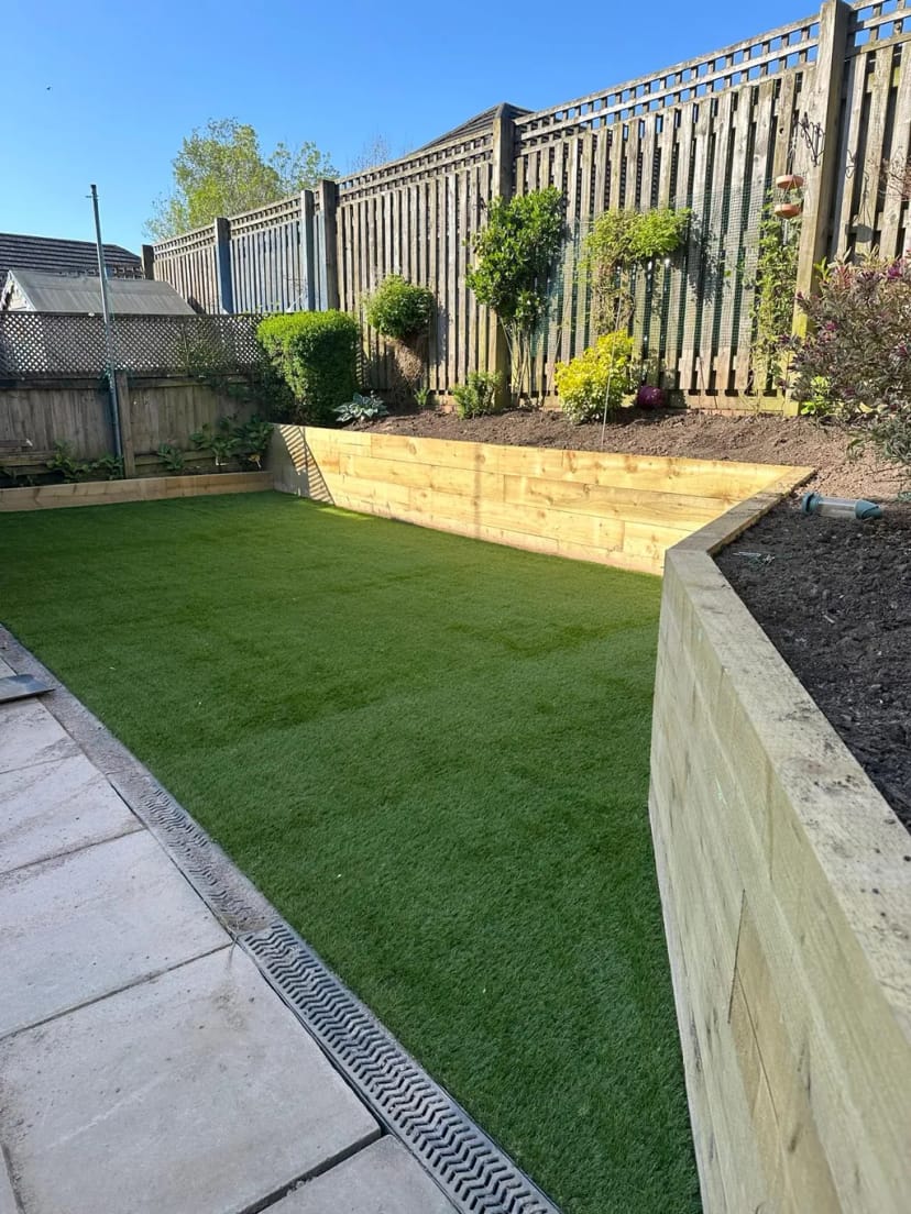 Retaining garden wall/planter with levelled astroturf area